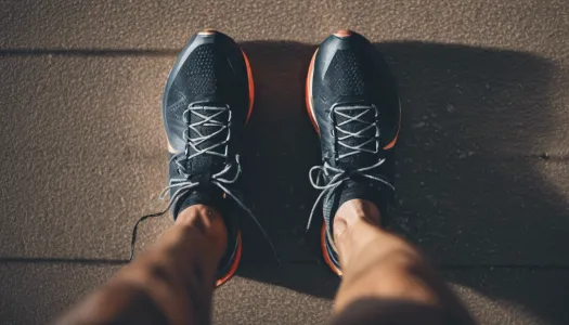 A close-up shot of a triathlete's running shoes and athletic wear